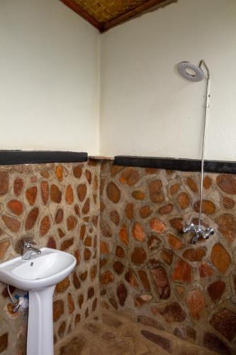 a bathroom with a sink and a shower at Karungi Camp in Rubuguli