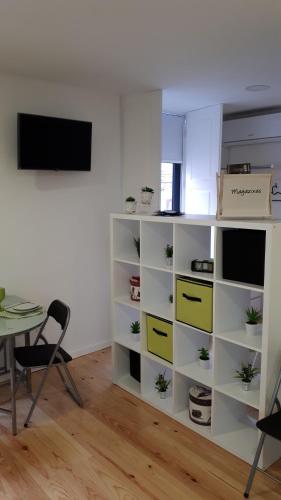 a room with a white book shelf with yellow drawers at TMB (Train / Metro& Bus ) Oporto Station House in Porto