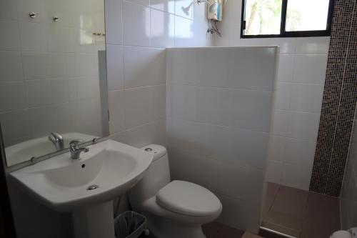 a bathroom with a sink and a toilet and a shower at Domicilio Lorenzo in Davao City