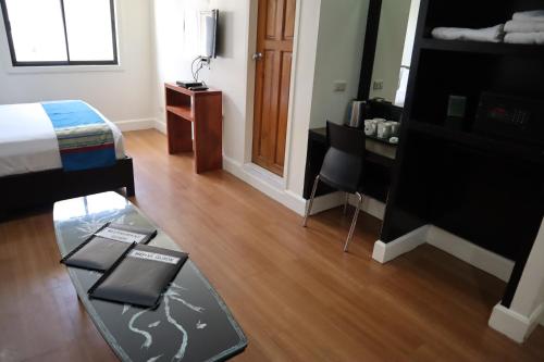a room with a bed and a table in a room at Domicilio Lorenzo in Davao City