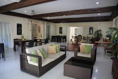 a living room with a couch and chairs and tables at Domicilio Lorenzo in Davao City