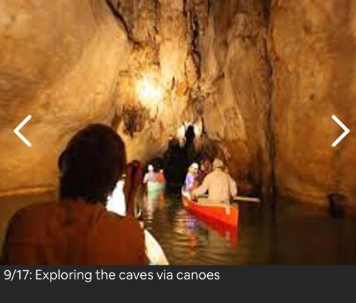 a group of people in a boat in a cave at Chupaflor - Alexander Luxury & Executive Suites in Belize City