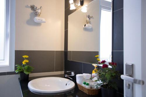 a bathroom with a sink and a toilet and a mirror at Dalat Eco Hotel in Da Lat