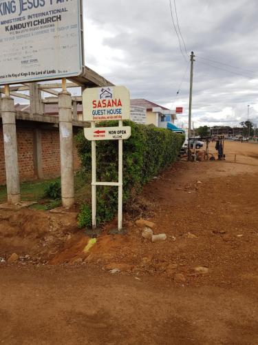 a sign for a samsina restaurant on the side of a road at Sasana Motel and Guest House in Bungoma