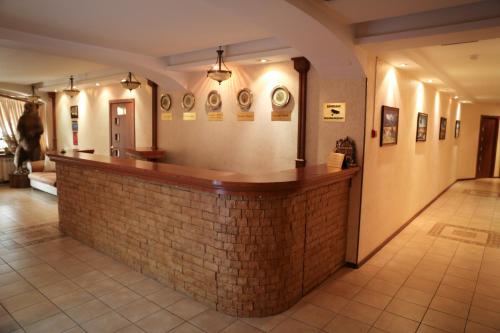 a bar in a room with a brick wall at Alpen Ville in Almaty