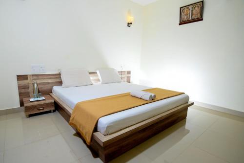 a bedroom with a large bed in a room at Shesha KUTEERA in Subrahmanya