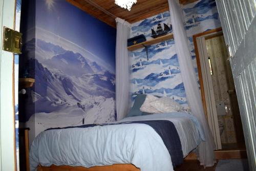 a bedroom with a mural of a mountain at Sasana Motel and Guest House in Bungoma