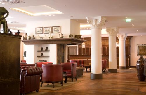 
a living room filled with furniture and a fire place at Lindner Park-Hotel Hagenbeck in Hamburg
