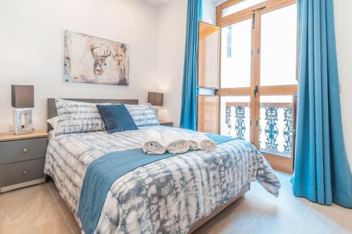 Ένα ή περισσότερα κρεβάτια σε δωμάτιο στο Valletta Collection - GB Suites