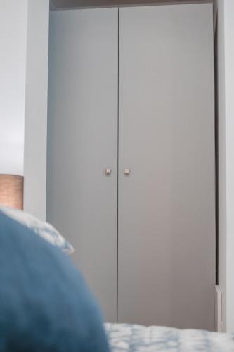 a pair of white closet doors in a bedroom at Valletta Collection - GB Suites in Valletta