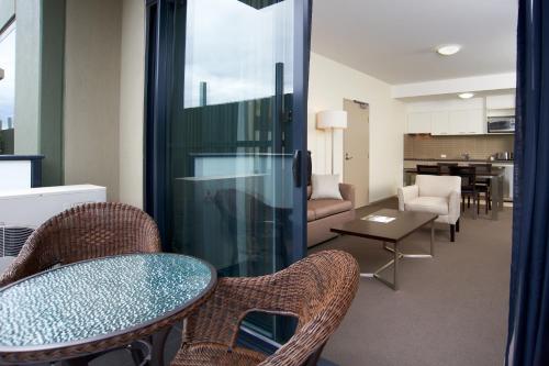 a living room with a table and chairs at Quest Moorabbin in Moorabbin