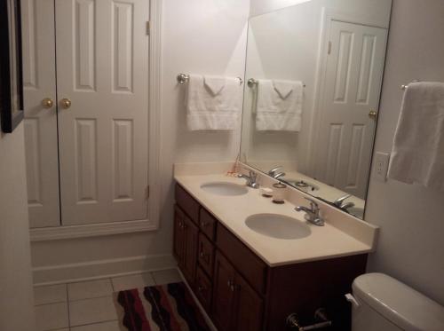 a bathroom with two sinks and a mirror at Ocean Reef 2 bedroom/2 bath! in Panama City Beach