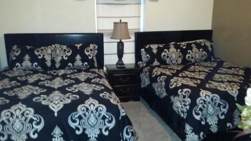 a bedroom with two beds with blue and white covers at Ocean Reef 2 bedroom/2 bath! in Panama City Beach