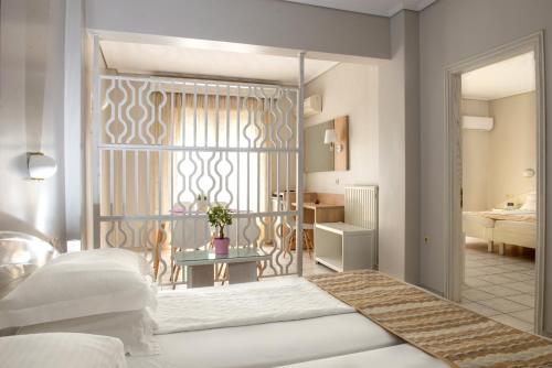 a rendering of a bedroom with a bed and a table at Hotel Strass in Paralia Katerinis