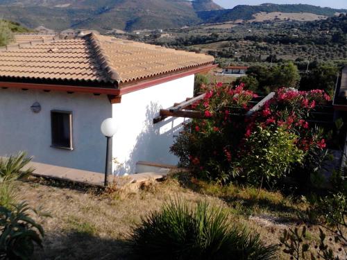 a white house with a view of a mountain at Affittacamere Valverde di Naitana Rita in Alghero