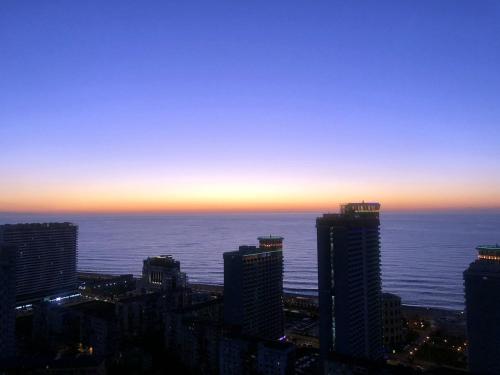 a view of a city skyline at sunset at Pirosmani Mini Hotel in Batumi