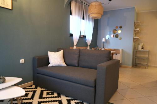 a living room with a blue couch and a table at Apartment Ivana in Novi Vinodolski