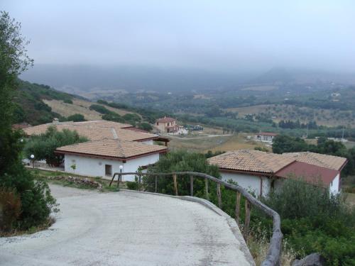 a winding road in a small village with houses at Affittacamere Valverde di Naitana Rita in Alghero