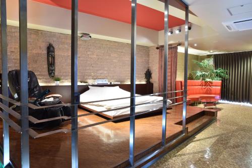 a room with a bed and a couch at C-HOTEL affetto(Adult Only) in Sapporo