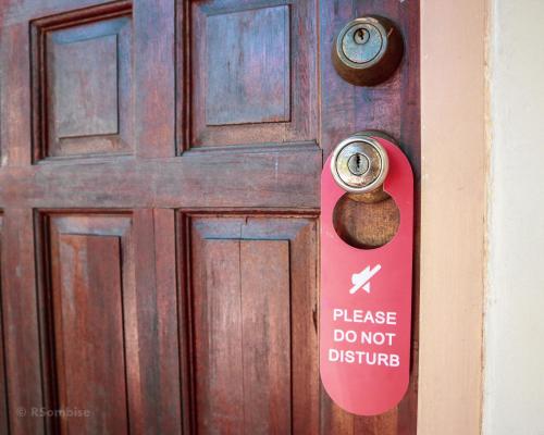 a door with a sign that says please do not disturb at RQS Hostel in Tacloban
