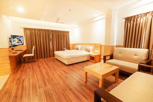 a living room with a bed and a couch at Hotel Elite Palazzo in Kāladi