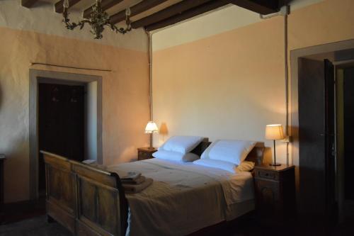 a bedroom with a large bed with white sheets and pillows at Locanda SottolaLuna in Viano