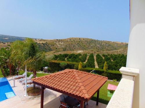 a view of a house with a tile roof at Golden Valley Villa in Skoulli