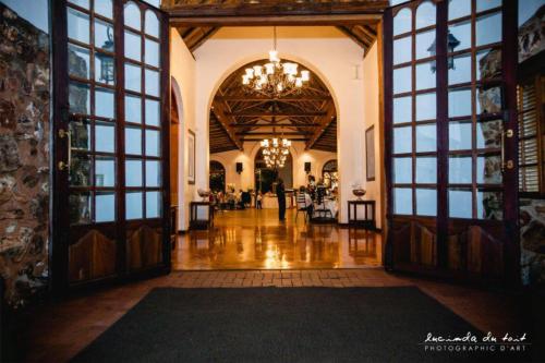 a hallway with large doors and a chandelier at Kleinkaap Boutique Hotel in Centurion