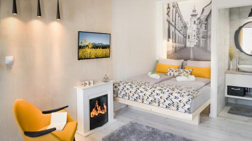a small bedroom with a bed and a fireplace at Luxury Studio 24 in Győr
