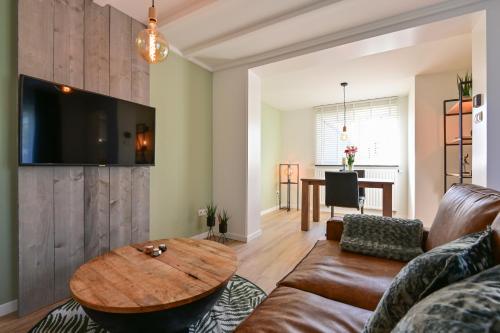 a living room with a couch and a table at Sibbliem Luxury Homestay in Valkenburg