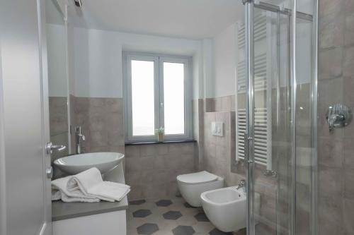 a bathroom with a toilet and a sink and a shower at Agriturismo Ca Du Briccu in Bardino Vecchio