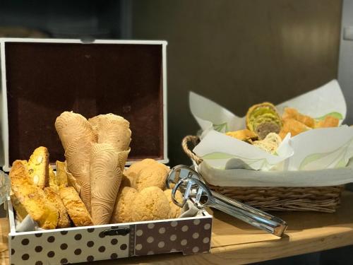 a box with a bunch of food and keys on a table at Relais dei Molini - Villa dei Molini in Castagneto Carducci