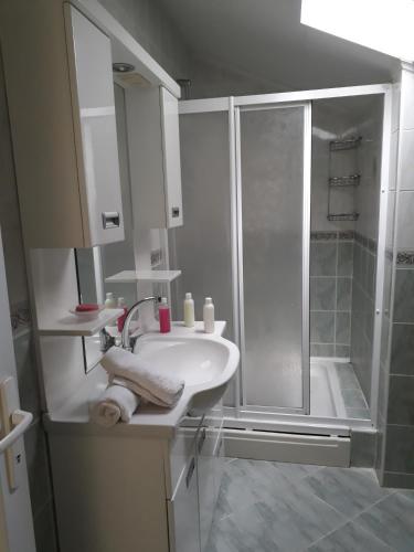 a white bathroom with a shower and a sink at Hotel NilSu in Oludeniz