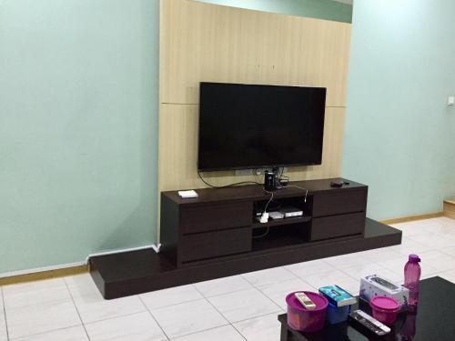 a flat screen tv sitting on a entertainment center at The oasis in Kuching