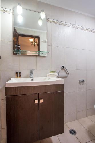 a bathroom with a sink and a mirror at CasaLindos Festa in Lindos