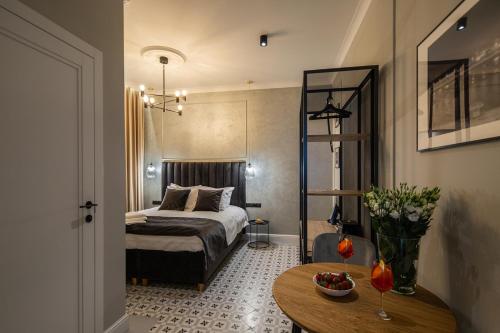 a bedroom with a bed and a table in a room at Apartamenty przy Monte Cassino in Sopot