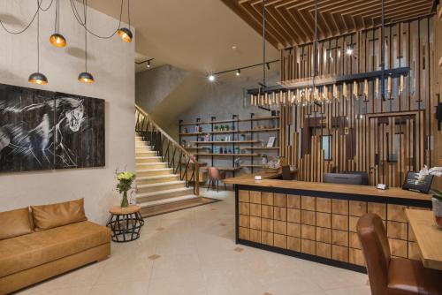a lobby with a couch and a bar and stairs at THE STAY Boutique Hotel Central Square - Free Compliments - Free Wi-Fi - TOP LOCATION - Available Parking in Plovdiv