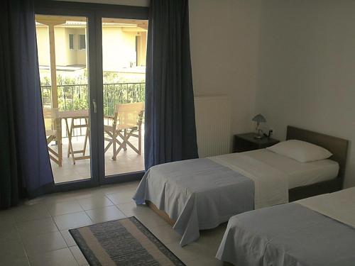 Postel nebo postele na pokoji v ubytování Hotel Alexandros