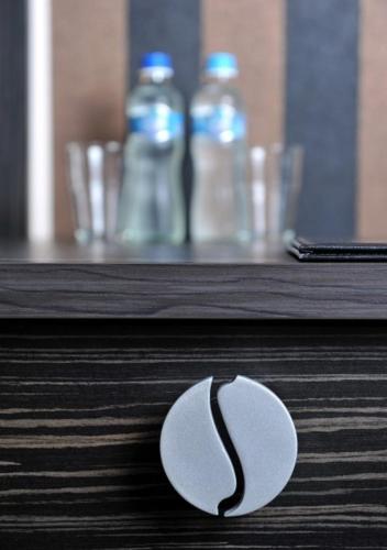a close up of a spoon on a table with water bottles at Hotel Sulbin in Garwolin