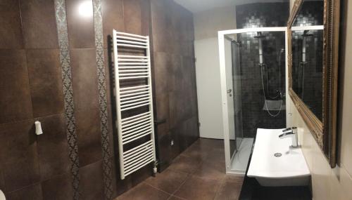 a bathroom with a sink and a shower and a mirror at Leticia in Biograd na Moru