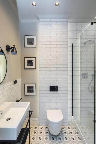 a bathroom with a toilet and a sink and a shower at Apartamenty przy Monte Cassino in Sopot