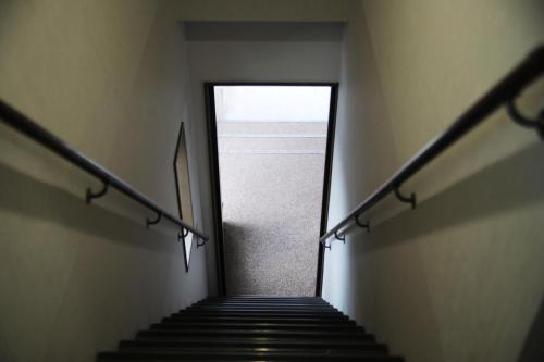 a stairway leading up to a door in a building at Stay Omihachiman Ekimae Inn in Omihachiman