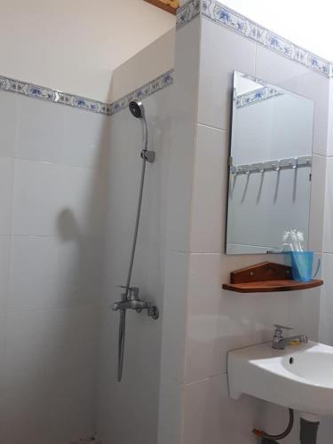 a bathroom with a shower and a sink at Hiep Hoa Resort in Mui Ne