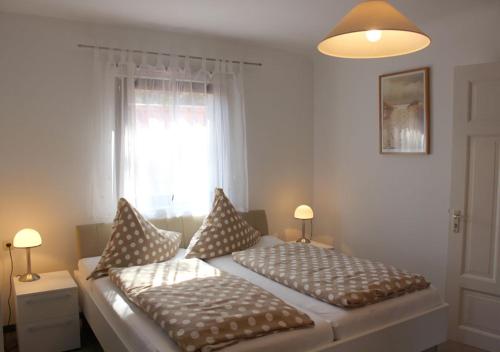a bedroom with two beds and a window at Villa Waldheim - WG 1 in Boltenhagen