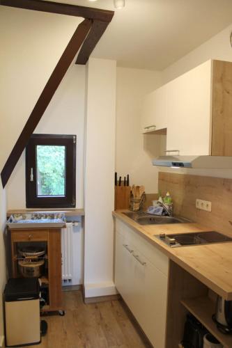 a kitchen with a counter and a window in it at Villa Waldheim - WG 1 in Boltenhagen