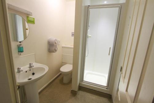 a bathroom with a shower and a toilet and a sink at YHA Snowdon Llanberis in Llanberis