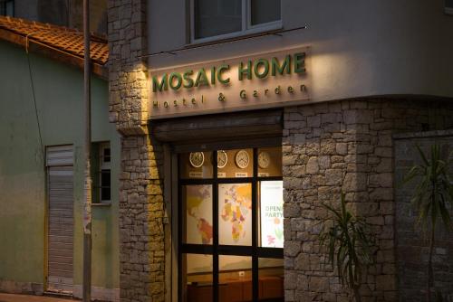 a masonic home sign on the side of a building at Mosaic Home in Tirana