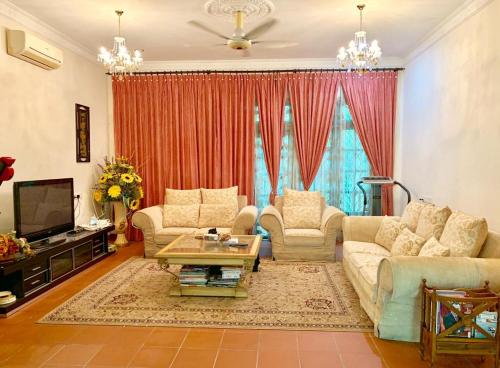 a living room with two couches and a tv at VILLA SHAMIR in Sepang