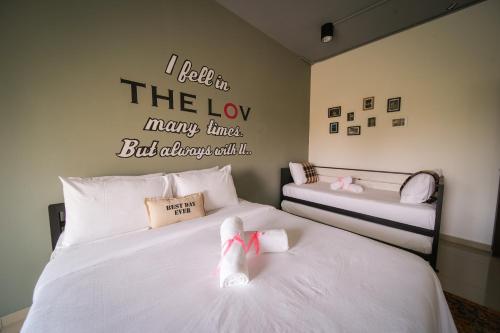 a bedroom with two beds with socks on them at The Best Hotel in Bayan Lepas - THE LOV PENANG in Bayan Lepas
