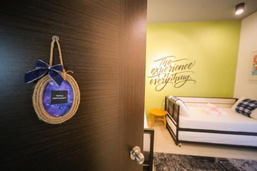 a room with a bed and a sign on a wall at The Best Hotel in Bayan Lepas - THE LOV PENANG in Bayan Lepas